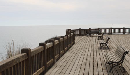Wooden esplanade on the sea shore with benches to relax in Retamar of AlmerÃ­aの写真素材