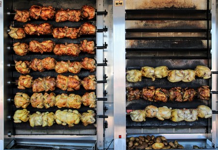 Juicy chickens roasted on the spit with a nice golden colorの写真素材