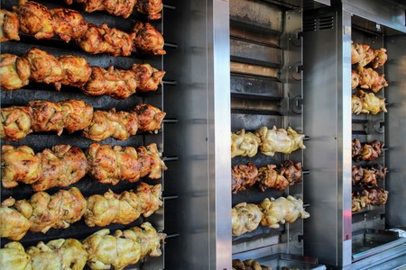 Juicy chickens roasted on the spit with a nice golden colorの写真素材