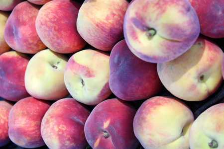 Fresh and sweet red peach at market stallの写真素材
