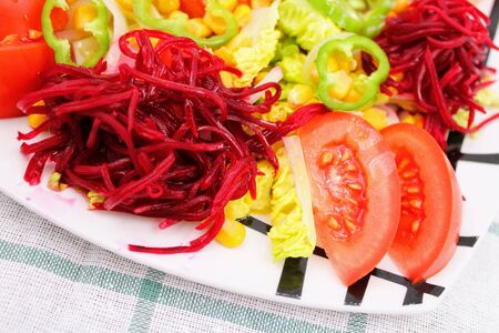 Colorful fresh vegetable salad with tomatoes , peppers , corn and lettuceの写真素材