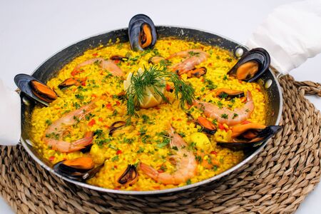 Pan with yellow rice and sea food rich mediterranean flavorの写真素材