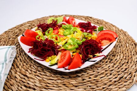 Colorful fresh vegetable salad with tomatoes , peppers , corn and lettuceの写真素材