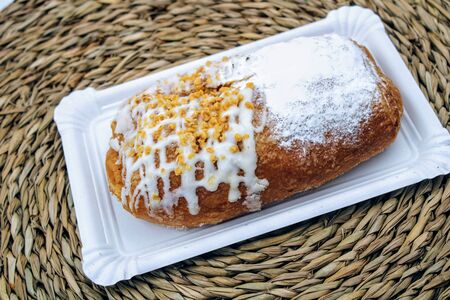 Portion of puff pastry filled with pastry cream and sprinkled with icing sugarの写真素材