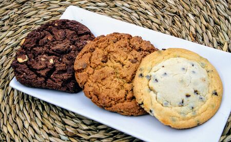 Round cookies of chocolate , oatmeal and vanilla with chocolate chipsの写真素材