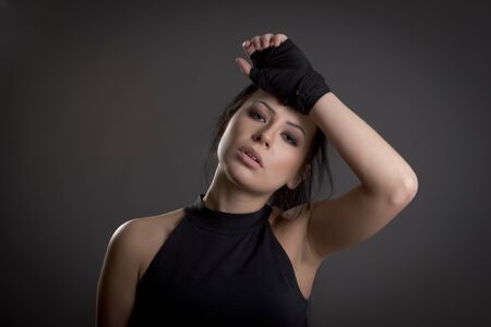 woman covered in bandages for boxing on a dark backgroundの写真素材