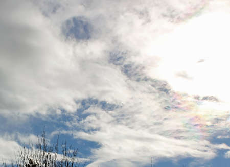 Rainbow radiating from the sun with a backdrop of clouds.の写真素材