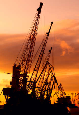 Silhouette of cranes show against the multicolored sundown. This is sunset in Odessa harbour...