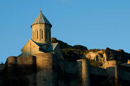 Ancient fortress Naricala is situated in Tbilisi, Georgia. Morning sun lights defensive wall and St....