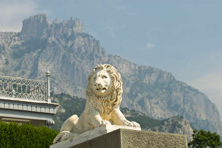 This marble lion sculpture is situated in Vorontsov Palace - Alupka, Crimea. The lion is situated against the famous Ay-Petry Mountains (Crimea).のeditorial素材