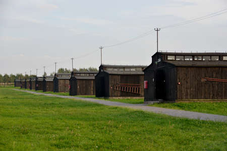 Wood barracks range in Majdanek concentration camp (Lublin, Poland). Bright green grass contrasts with morose buildings.のeditorial素材