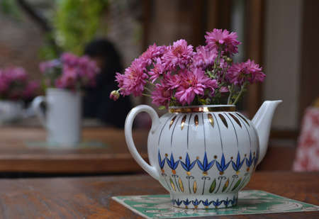Violet flowers chrysanthemum in the ceramic teapot.の写真素材