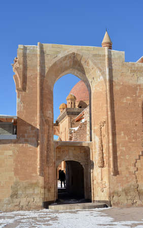 Entrance to old Ottoman Ishak Pasha Palace and architecture details Turkey, slopes of mount Ararat Agri. Buildings are situated against the blue sky background.のeditorial素材