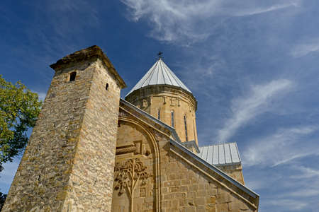 Ananuri church and fortress tower against beautiful sky background.  Cirrus clouds  become the...