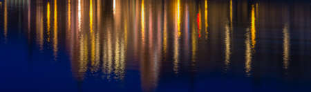 Abstraction. Multicolored water reflection of illuminated city.