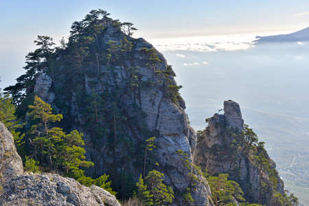 Beautiful rocks with pines in Ghost Valley (Crimea). Rocks against clouds background.の写真素材