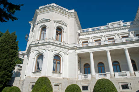 Livadia Palace against blue sky background. Green bushes and trees soup the composition.のeditorial素材