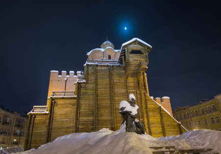 Illuminated Golden Gates and Yaroslav the Wise monument (Kiev). Winter scene.のeditorial素材