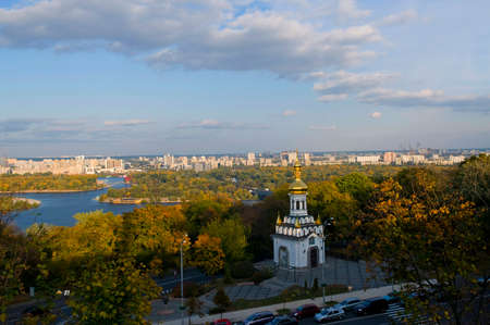 Andrew the First-called church surrounded with autumn trees. Modern Kiev buildings in background.の写真素材