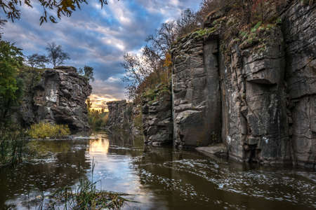 Buky Canyon (River Hirs'kyi Tikych - Ukraine) in autumn season. Beautiful clouds reflect in water.の写真素材