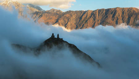 Gergeti Trinity Church (Georgia) surrounded with clouds.