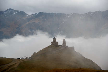 Gergeti Trinity Church (Georgia) surrounded with clouds.