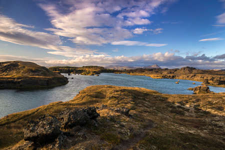 Beautiful autumn landscape with Myvatn lake (Iceland). North sky with clouds in background.の写真素材