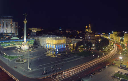 Top view of Maidan Nezalezhnosti square at evening time. Buildings are illuminated. Blossom  horse chestnut trees are seen on the photo.の写真素材