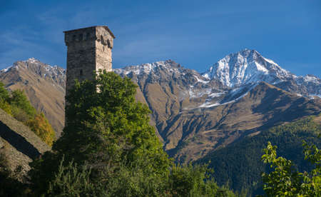 Old Svaneti tower against Caucasus Mountains background.の写真素材