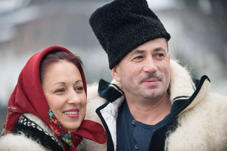 Married couple dressed in winter traditional Romanian (Maramuresh region) clothes. Outdoor scene.のeditorial素材