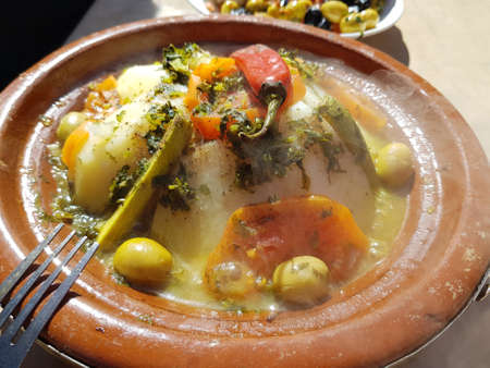 Hot vegeterian tajine. Fork fragment appears on a dish.の写真素材