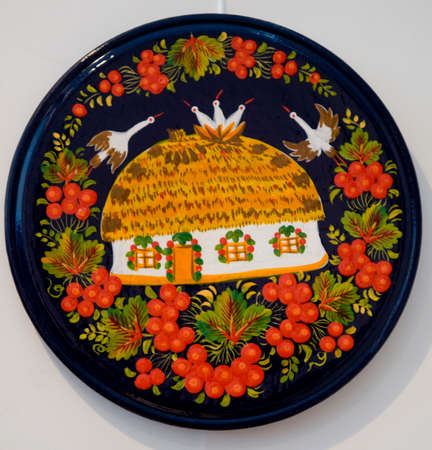 Petrykivka decorative painting. Plate with home and pattern.の写真素材