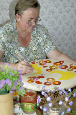 Petrykivka, Dnipropetrovsk Oblast/Ukraine - 02.28.2009. Artist - specialist in Petryakov painting at work.のeditorial素材