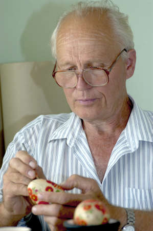 Petrykivka, Dnipropetrovsk Oblast/Ukraine - 02.28.2009. Artist paints Easter egg in folk style.のeditorial素材