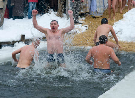 Mamaeva Sloboda, Kiev, Kievskaya Oblast/Ukraine - 01.19.2010. Epiphany Day in Orthodoxy (or Baptism of Jesus holiday). Men in ice hole.のeditorial素材
