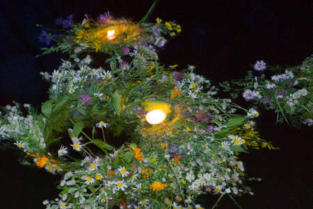 Celebration of Ivan Kupala. Wreathes with candles on water. Night scene.の写真素材