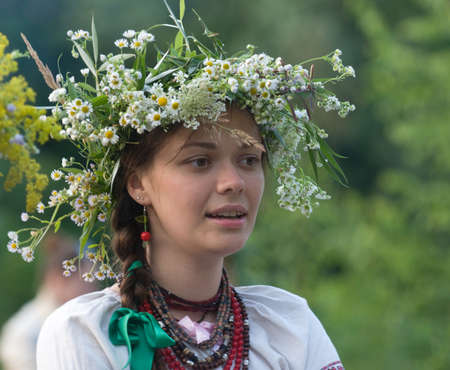 Girl in beautiful wreath. Summer season and holiday.のeditorial素材