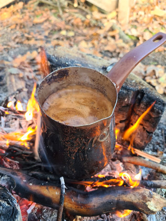 Coffee is prepared in cezve on fire. Vertical image.の写真素材