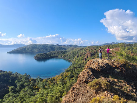 Girls on rock against beautiful seascape of Datca Peninsula (Turkey).の写真素材
