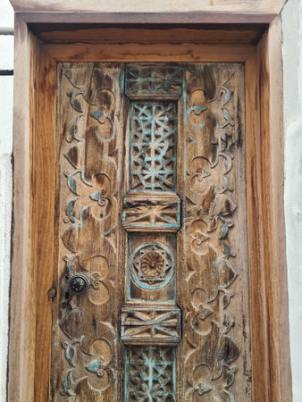 Wooden beautiful old doors in Bodrum. Door is decorated with wood carvings.の写真素材