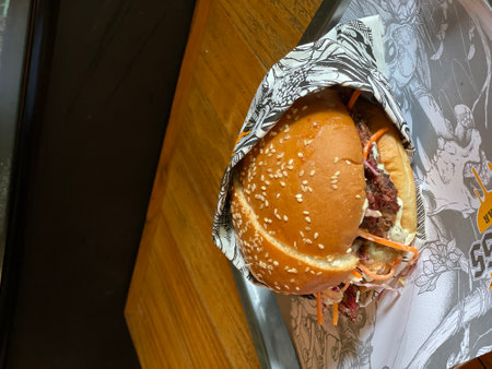 A delicious cheese burger on the wooden tableの写真素材