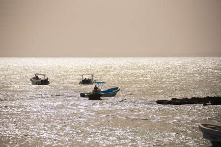 Tourists in boats near the shore in Bayahibe, La Altagracia, Dominican Republic. Copy space for textのeditorial素材