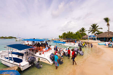 BAYAHIBE, DOMINICAN REPUBLIC - MAY 21, 2017: Tourists get into boats. Copy space for textのeditorial素材