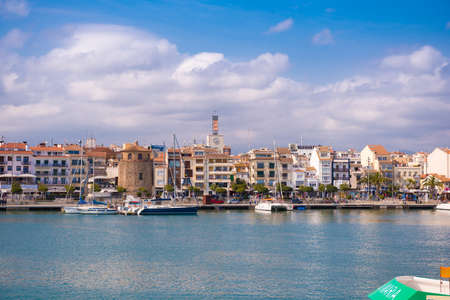 CAMBRILS, SPAIN - APRIL 30, 2017: View of port and city waterfront with Church Of Saint Peter in middle and Torre del Port. Copy space. Space for textのeditorial素材