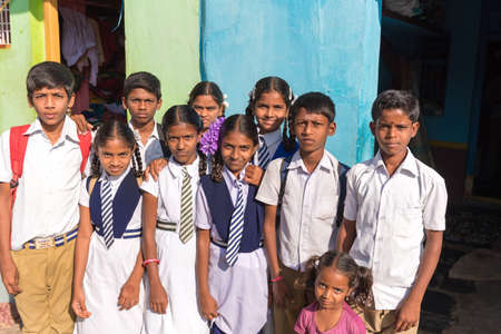 PUTTAPARTHI, ANDHRA PRADESH - INDIA - NOVEMBER 09, 2016: Indian school children are posing on the streetのeditorial素材
