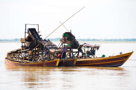 MANDALAY, MYANMAR - DECEMBER 1, 2016: Floating dredge for the extraction of gold and precious stones, Irravarddy river, Burma. Copy space for textのeditorial素材