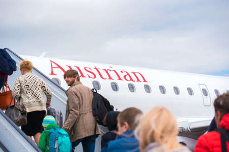 BARCELONA, SPAIN - AUGUST 20, 2016: Passengers enter the plane. Austrian Airlines. Copy spaceのeditorial素材