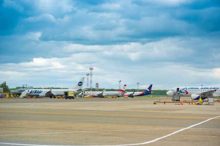 KRASNODAR, RUSSIA - APRIL 19, 2017: Aircraft of different airlines at the airport. Storm clouds in the sky. Copy space. Space for textのeditorial素材