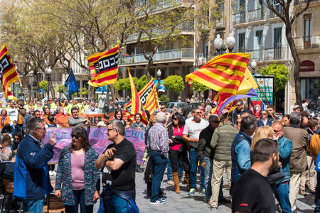 Tarragona, Spain - 01, 05, 2017: People with flags at the street of Tarragona at the 1st of may, international celebrationのeditorial素材