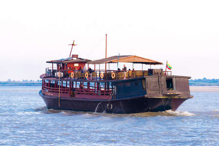 MANDALAY, MYANMAR - DECEMBER 1, 2016: Pleasure boat on the river Irravarddy, Burma. Copy space for textのeditorial素材